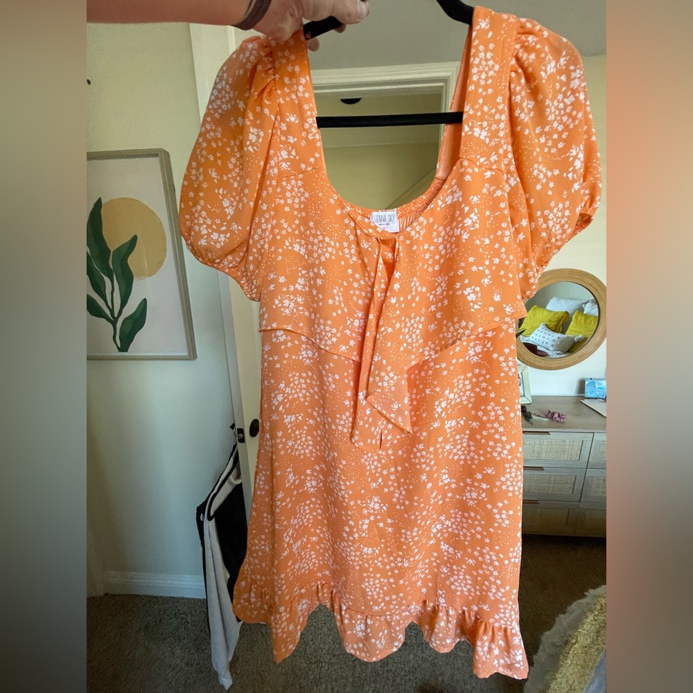 Cute orange dress with white flowers. Size Medium.